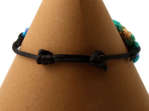Multi-coloured adjustable bracelet. Tapestry crochet and black chord, adjustable length 16 - 21 cm back view