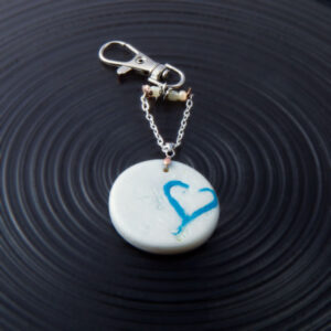 Blue Heart inlaid in pearl polymer clay circle. Handbag charm